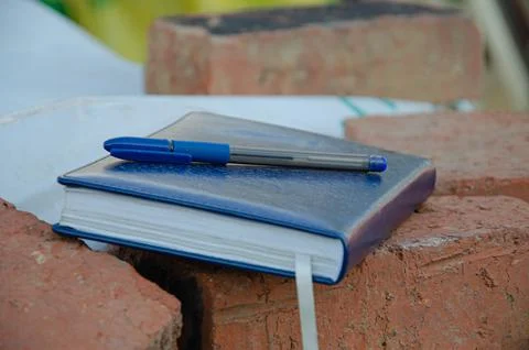 The text Study on a wooden cubes, lying on a Notepad with a metal blue pen. B Stock Photos