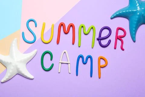 Text SUMMER CAMP made of modelling clay and decorative starfishes on color ba Stock Photos