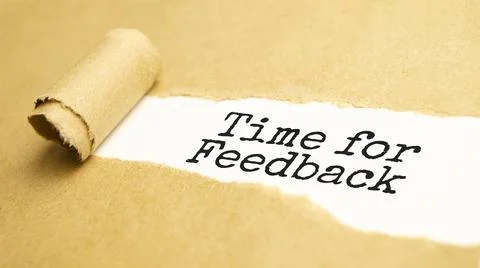 The text time for feedback appearing behind torn brown paper Stock Photos
