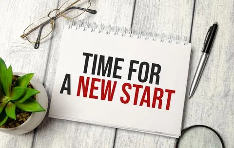 Text Time for a new start on notebook on wooden background Stock Photos