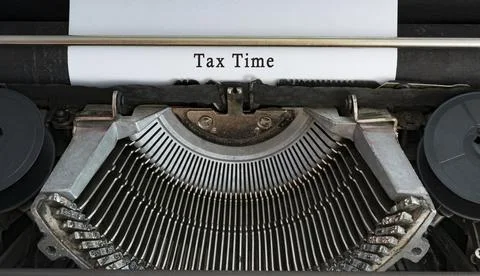 Text typed on an old classic typewriter - Tax time. Business concept. Stock Photos