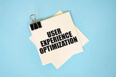Text USER EXPERIENCE OPTIMIZATION on sticky notes with copy space and paper.. Stockfoto's