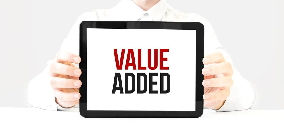 Text value added on tablet display in businessman hands on the white bakcgrou Stock Photos