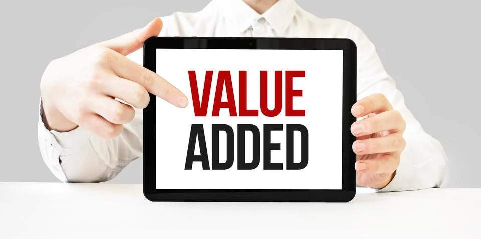 Text value added on tablet display in businessman hands on the white bakcgrou Stock Photos