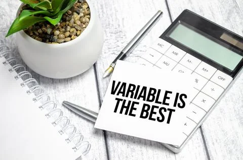 Text variable is the best on paper card and calculator on wooden background Stock Photos