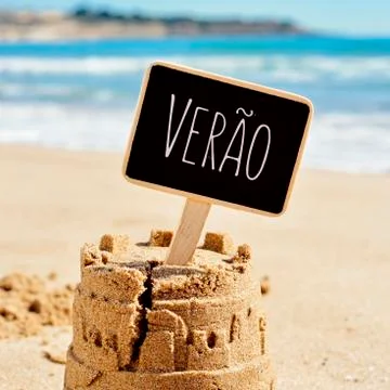 Text verao, summer in Portuguese, in a sandcastle Stock Photos