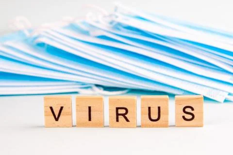 Text "virus" with copy space on the background of protective face masks. Viru Stock Photos
