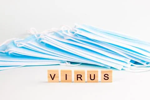 Text "virus" with copy space on the background of protective face masks. Viru Stock Photos
