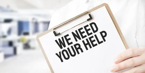 Text We need your Help on white paper plate in businessman hands in office. B Stock Photos