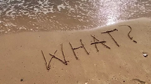 Text What? handwritten in sand surface. Blue ocean wave washing away questi.. 스톡 동영상 251800684