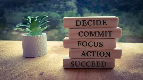 Text on wooden blocks - Decide, Commit, Focus, Action and Succeed. Plant and Stock Photos