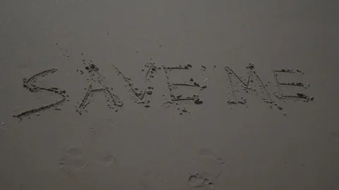 Text Words "save me" Drawn In The Sand at the beach ocean. sos help concept. Stock Footage 100174367