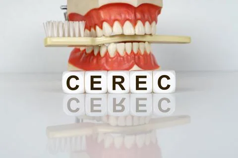The text is written on the cubes - CEREC. In the background, a model of the j Stock Photos