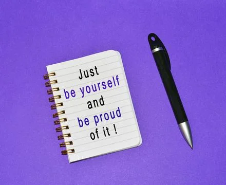 Text written on note pad and a pen with purple background Stock Photos