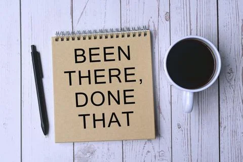 Text written on notebook with cup of coffee and pen on wooden background Stock Photos