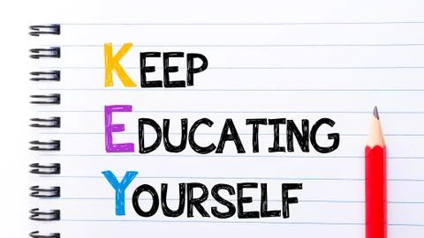 Text written on notebook page KEY as Keep Educating Yourself  Stock Photos