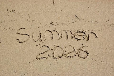 Text written in sand on beach, summer 2026 message visible Stock Photos