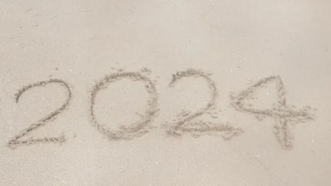Text year 2024 from hand writing on white sand surface beach in thailand re.. Stock Footage 277354554