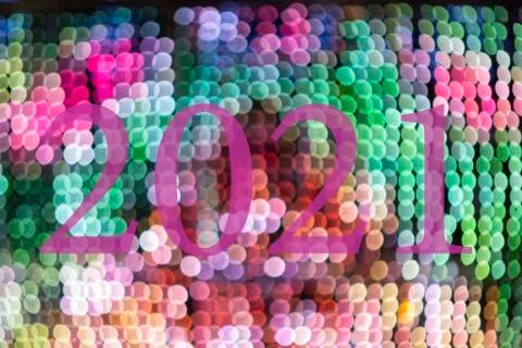Text with the year number 2021 with a background of bright out of focus lights Stock Illustration