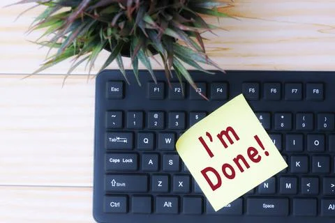 Text on yellow stick note on top of black keyboard Stock Photos