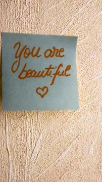 Text You are beautiful on post it. Writing on colorful sticky note. Buchare.. Stock Photos