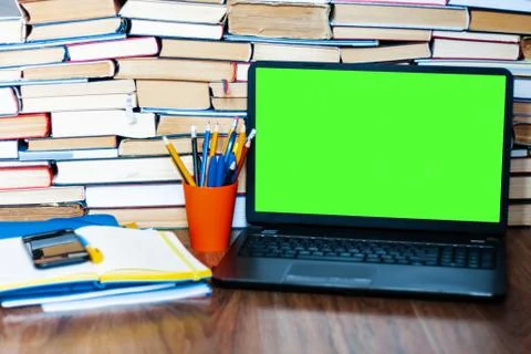 Textbook, notebook, green screen laptope and stack of books. Work from home, Stock Photos