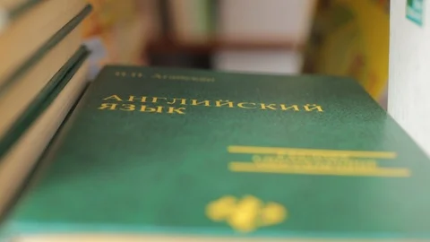 Textbooks on the shelf Video stock 126478576