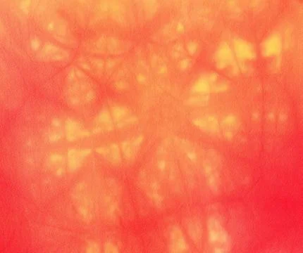 Textile background - batik in red and yellow Stock Photos