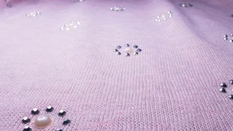 Textile background. close up. details of pink knitted fabric with rhinestones Video stock 135139963