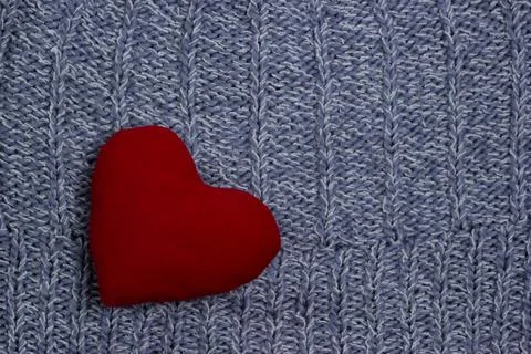 Textile background. red heart on the soft knitted blanket. Valentines day con Stock Photos