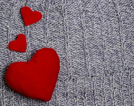 Textile background. red hearts on the soft knitted blanket. Valentines day co Stock Photos
