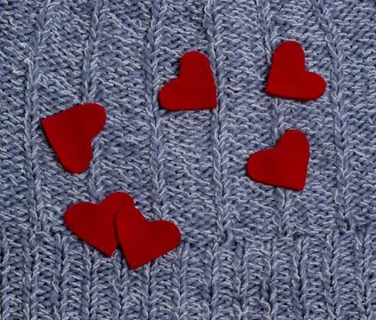 Textile background. red hearts on the soft knitted blanket. Valentines day co Stock Photos