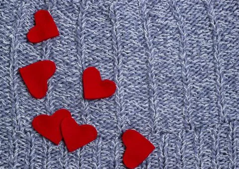 Textile background. red hearts on the soft knitted blanket. Valentines day co Stock Photos