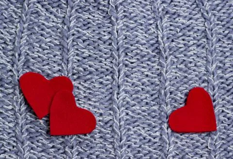 Textile background. red hearts on the soft knitted blanket. Valentines day co Stock Photos