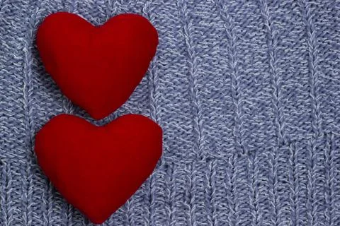 Textile background. Two red hearts on the soft knitted blanket. Valentines Stock Photos