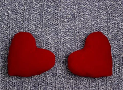 Textile background. Two red hearts on the soft knitted blanket. Valentines da Stock Photos