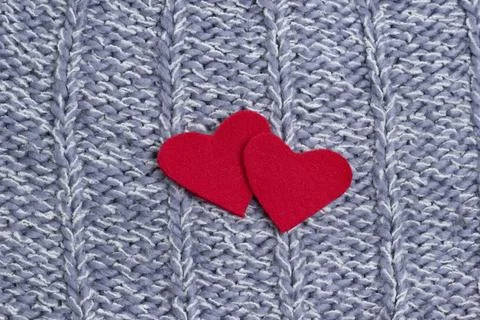 Textile background. Two red hearts on the soft knitted blanket. Valentines da Stock Photos