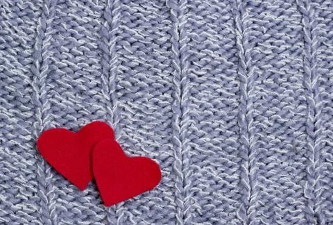 Textile background. Two red hearts on the soft knitted blanket. Valentines da Stock Photos