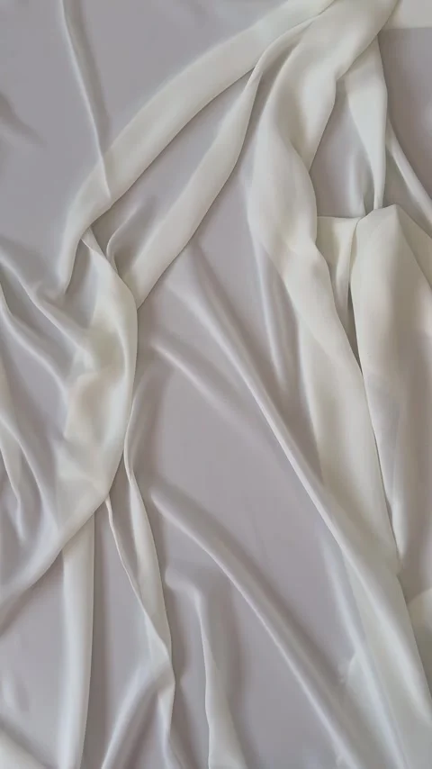 Textile background of white silk fabric with folds and drapes on cutting table Stock Footage 306561063