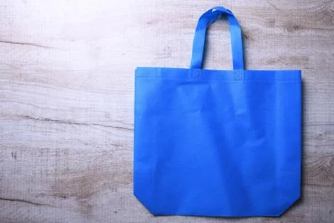 Textile bag on wooden background Stock Photos