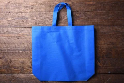 Textile bag on wooden background Stock Photos