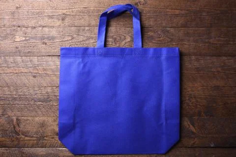Textile bag on wooden background Stock Photos