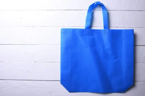 Textile bag on wooden background Stock Photos