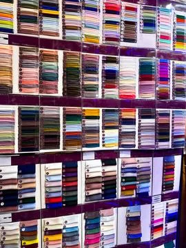 Textile Fabric Samples Displayed in Traditional Dubai Market Stock Photos
