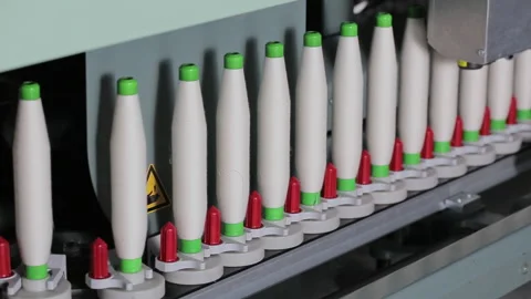 A textile factory. Coils with wound thread move along the conveyor of spinning Video stock 263016859