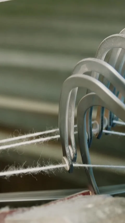 Textile factory. Weaving. Close-up shot of automated weaving machine parts in Stock-Footage 317439735