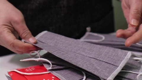 Textile factory worker checking finished fabric masks 動画素材 168580470