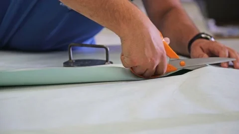 Textile factory worker cuts a fabric with scissors Stock Footage 69854860