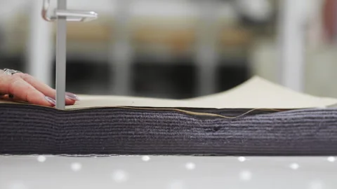 Textile factory worker cuts several layers of fabric. Stock Footage 280452884
