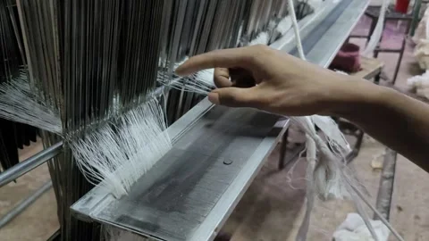 Textile Factory Worker Manually Knotting Warp Threads on a Power Loom 库存影片 337546399